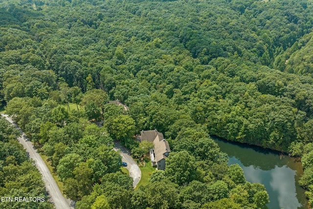 drone / aerial view with a water view and a wooded view