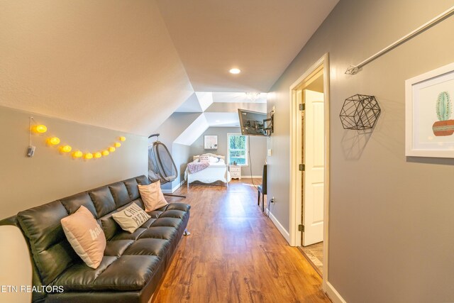 living room with vaulted ceiling and hardwood / wood-style floors