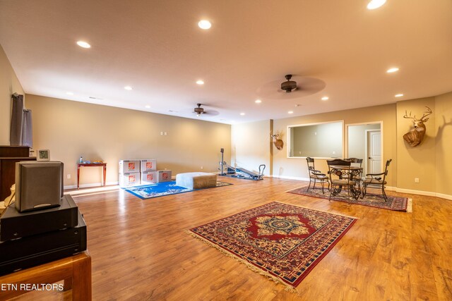 living room featuring wood-type flooring and ceiling fan