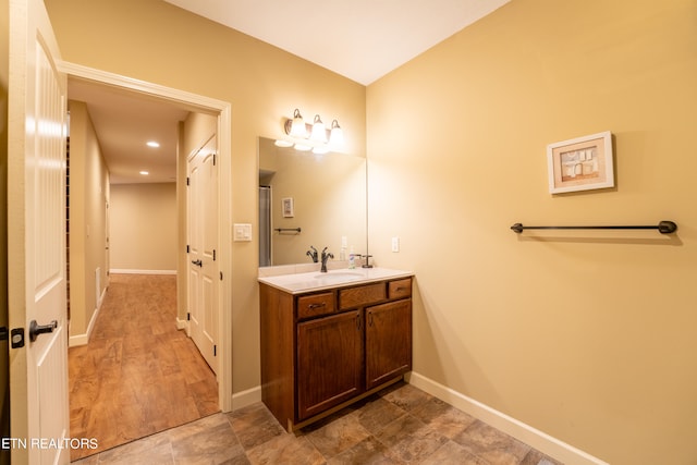 bathroom with hardwood / wood-style flooring and vanity