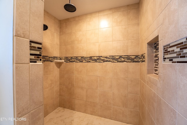 bathroom with a tile shower