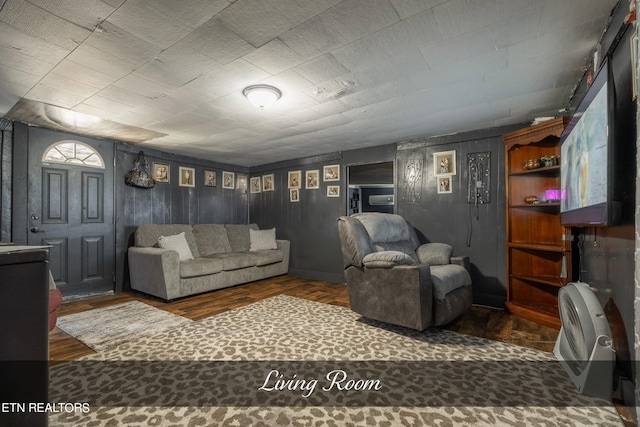 living room with dark hardwood / wood-style floors and built in features