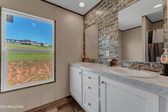 bathroom featuring dual vanity and hardwood / wood-style flooring