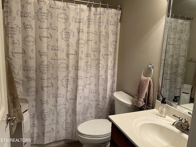 bathroom featuring vanity, toilet, and a shower with shower curtain