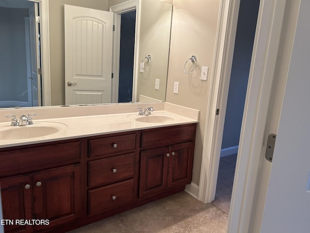 bathroom with a sink and double vanity