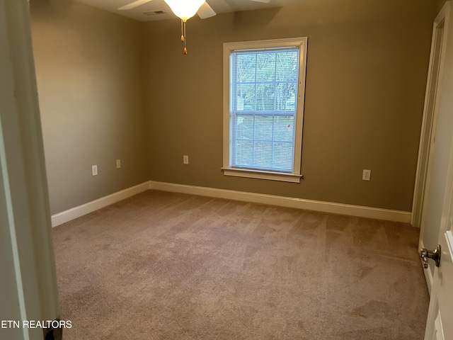 carpeted spare room with baseboards and ceiling fan