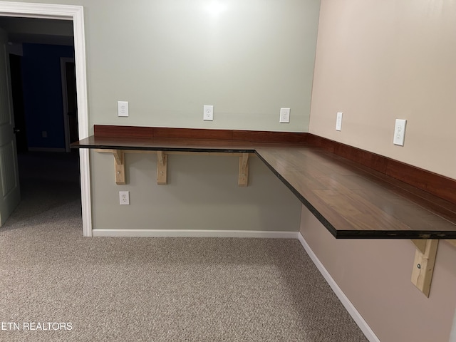 carpeted spare room featuring baseboards