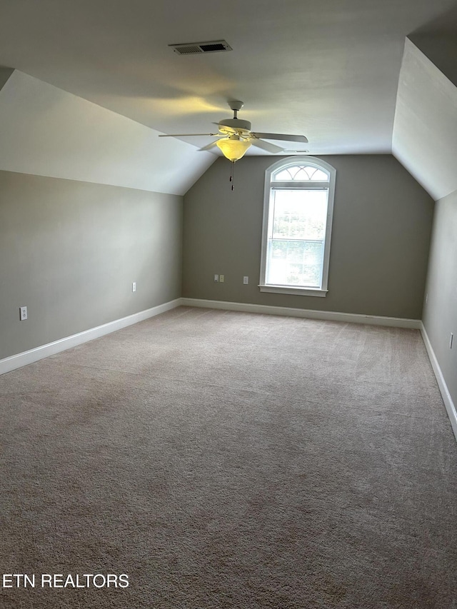 bonus room featuring baseboards, carpet, ceiling fan, and lofted ceiling