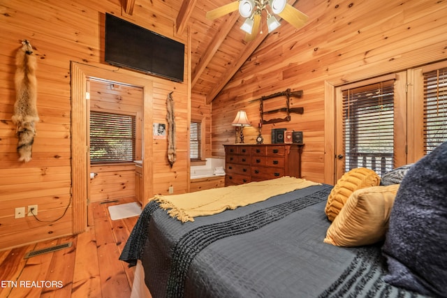 bedroom featuring ceiling fan, wooden walls, beam ceiling, wooden ceiling, and hardwood / wood-style flooring