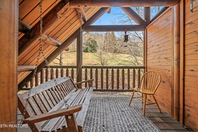 sunroom / solarium featuring a wealth of natural light and vaulted ceiling