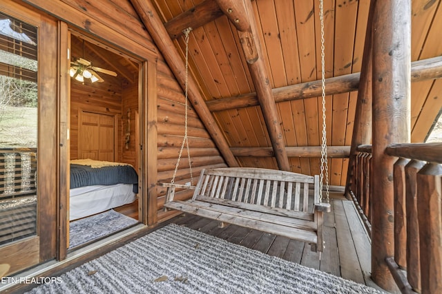 interior space featuring dark wood-style floors, wooden ceiling, vaulted ceiling with beams, and log walls