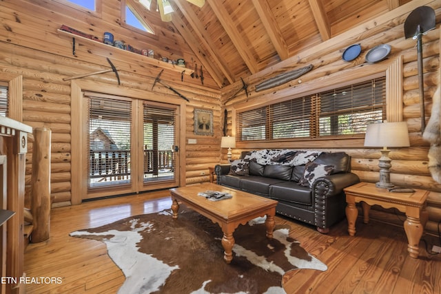 living room with high vaulted ceiling, a wealth of natural light, and wood finished floors