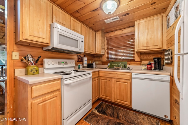 kitchen with sink, light brown cabinets, dark hardwood / wood-style flooring, white appliances, and wooden ceiling