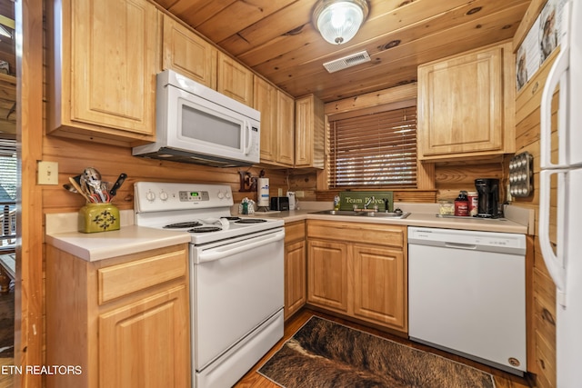 kitchen featuring white appliances, a sink, visible vents, wood ceiling, and light countertops