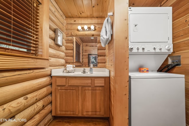 half bathroom with wood ceiling, vanity, wood finished floors, and stacked washer and clothes dryer