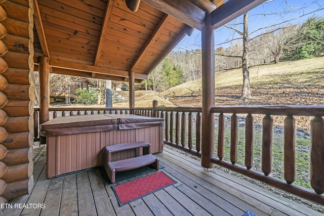 wooden terrace featuring a hot tub