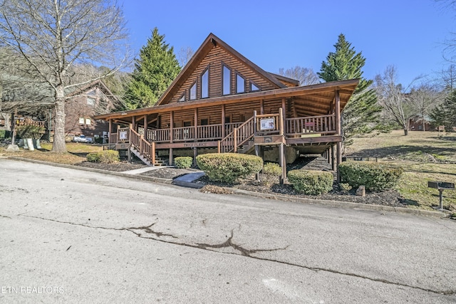 view of front of property with covered porch and stairway