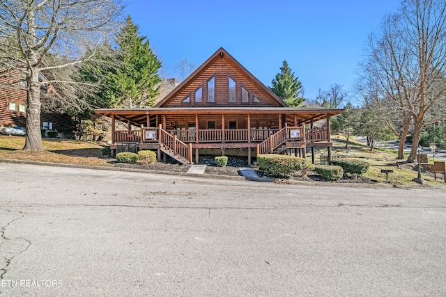 log home featuring covered porch