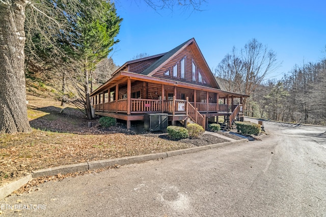 log-style house featuring a porch