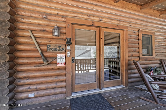 property entrance with log siding