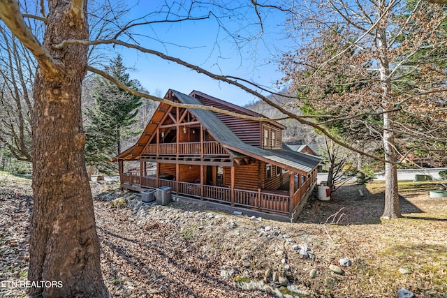 back of house featuring a deck and central AC