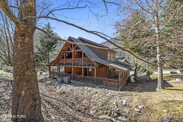 rear view of property with log exterior