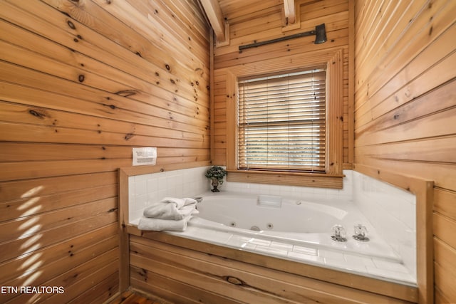 full bath with a jetted tub and wooden walls