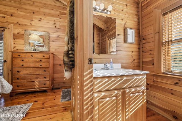 bathroom featuring wood walls and wood-type flooring