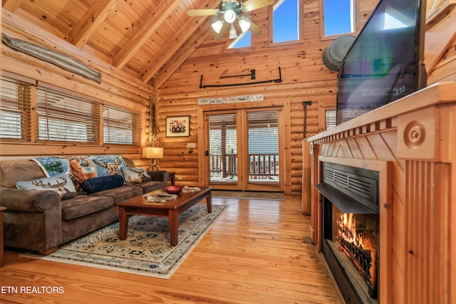 living room featuring high vaulted ceiling, light wood-type flooring, beam ceiling, ceiling fan, and wood ceiling