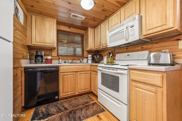 kitchen with light countertops, visible vents, wooden ceiling, light brown cabinets, and white appliances