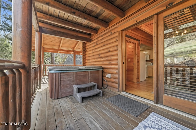 wooden terrace featuring a hot tub