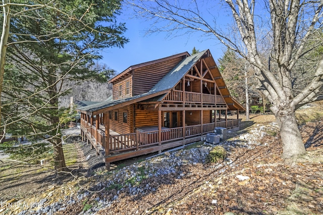 rear view of property with a shingled roof