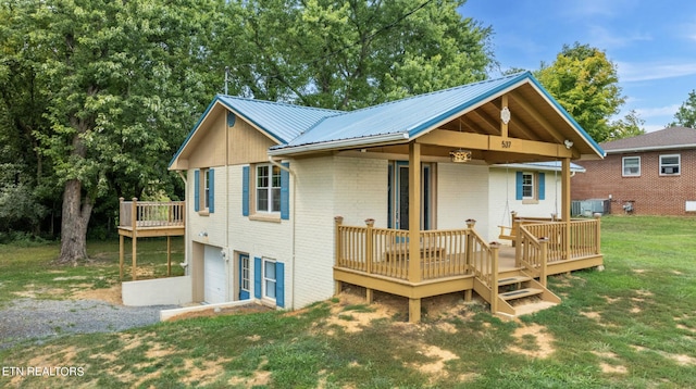 back of property with a wooden deck, central AC unit, and a yard