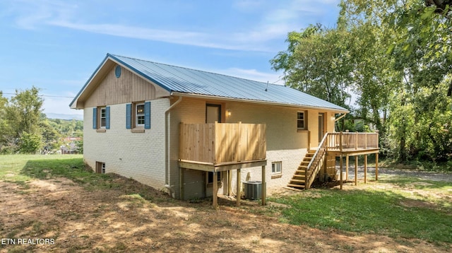 back of house featuring cooling unit and a deck