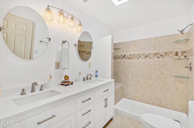 bathroom with tile patterned flooring, double sink vanity, and toilet