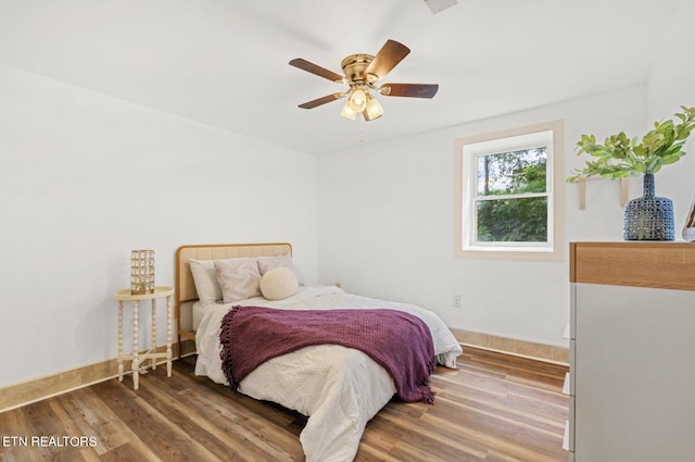 bedroom with ceiling fan and wood-type flooring