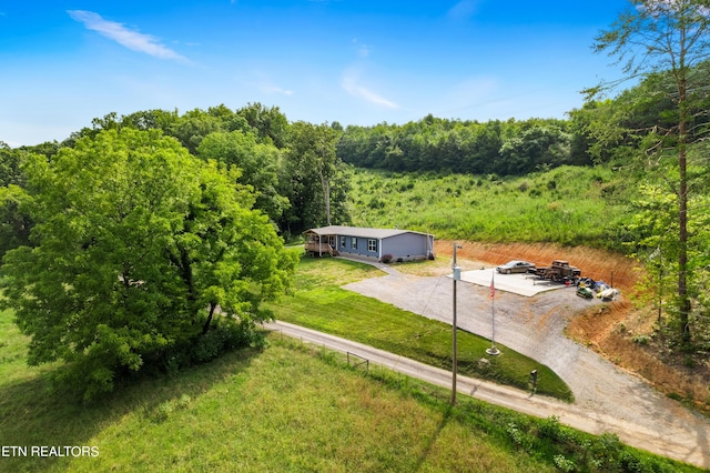 drone / aerial view featuring a forest view