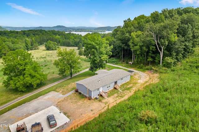 drone / aerial view featuring a mountain view and a wooded view