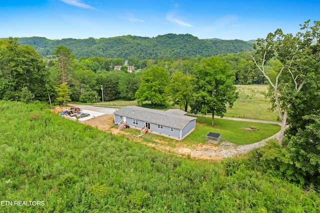 drone / aerial view featuring a forest view