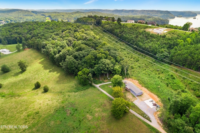 birds eye view of property featuring a view of trees