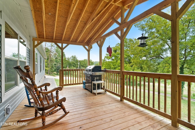 wooden deck featuring area for grilling