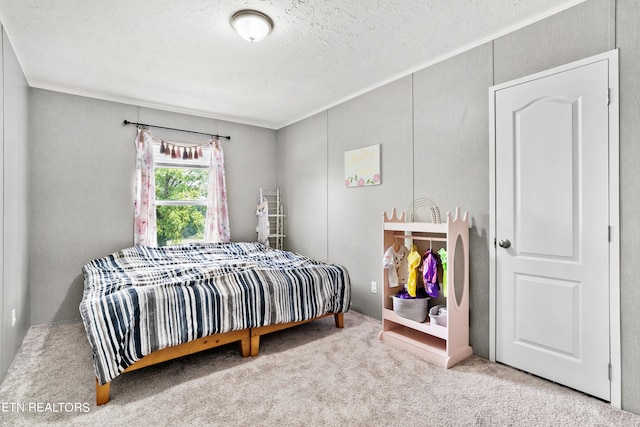 bedroom with a textured ceiling and carpet