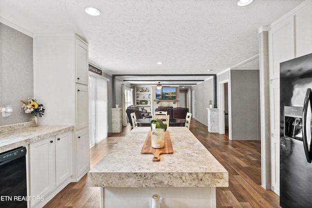 kitchen with a textured ceiling, white cabinetry, black appliances, and dark hardwood / wood-style floors