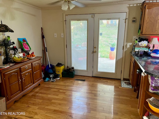 doorway to outside featuring french doors, crown molding, light hardwood / wood-style flooring, and ceiling fan