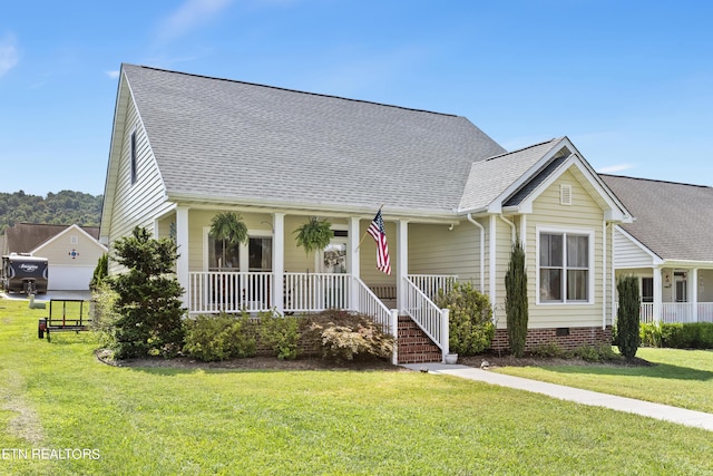 view of front of home with covered porch, roof with shingles, a front lawn, and crawl space