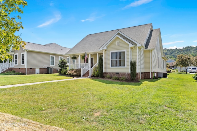 view of front of home with central air condition unit, a front lawn, and covered porch