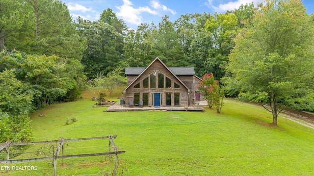 rear view of house featuring a lawn