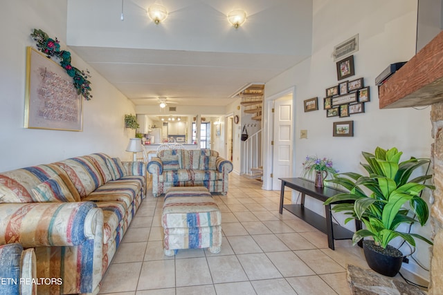 tiled living room featuring ceiling fan