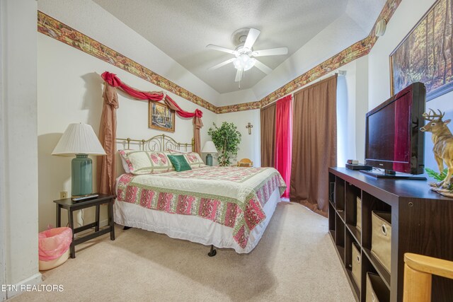 bedroom with a textured ceiling, ceiling fan, vaulted ceiling, and light colored carpet