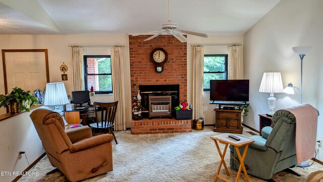 carpeted living room with a textured ceiling, brick wall, ceiling fan, and a brick fireplace